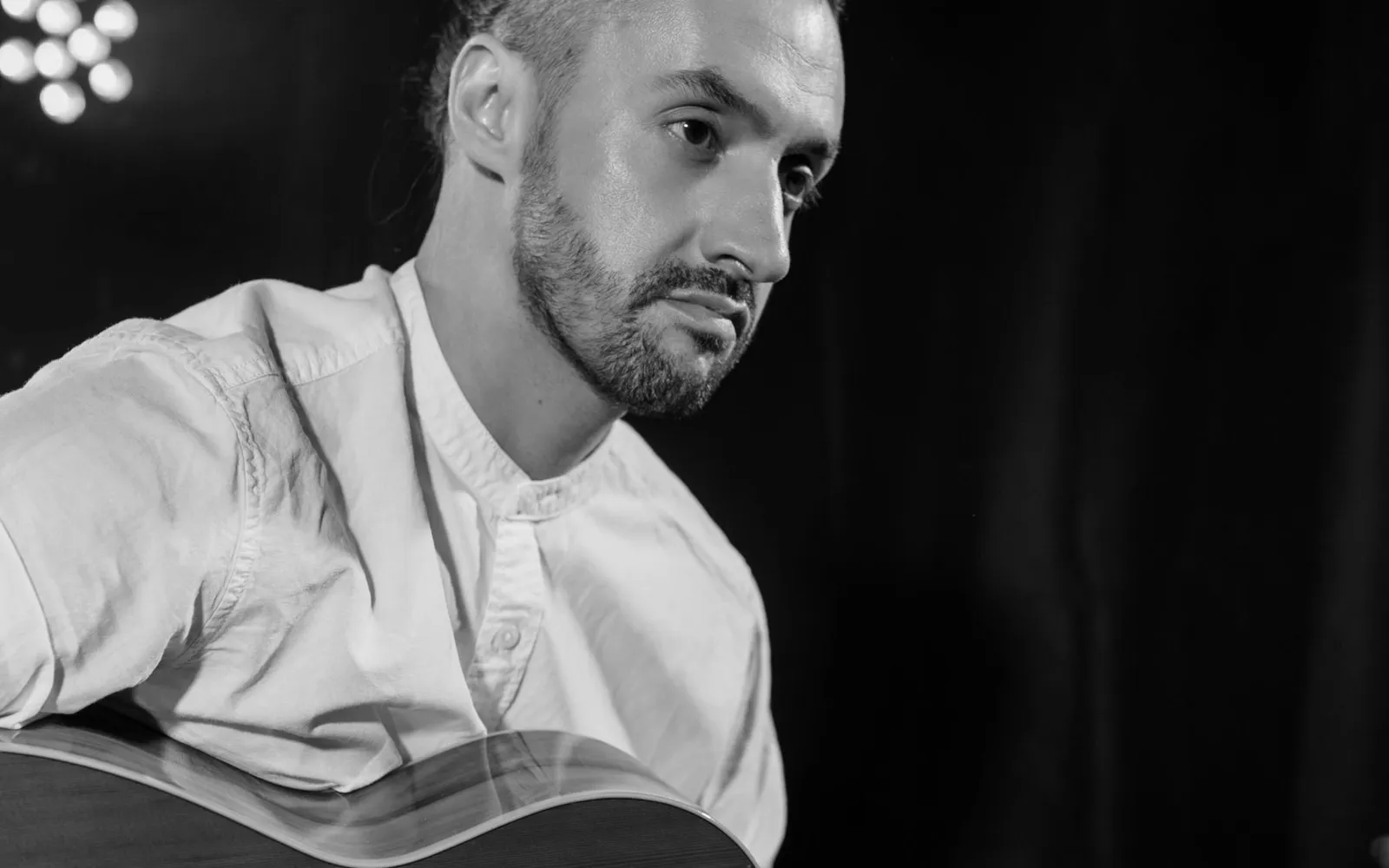 A musician performing with an acoustic guitar