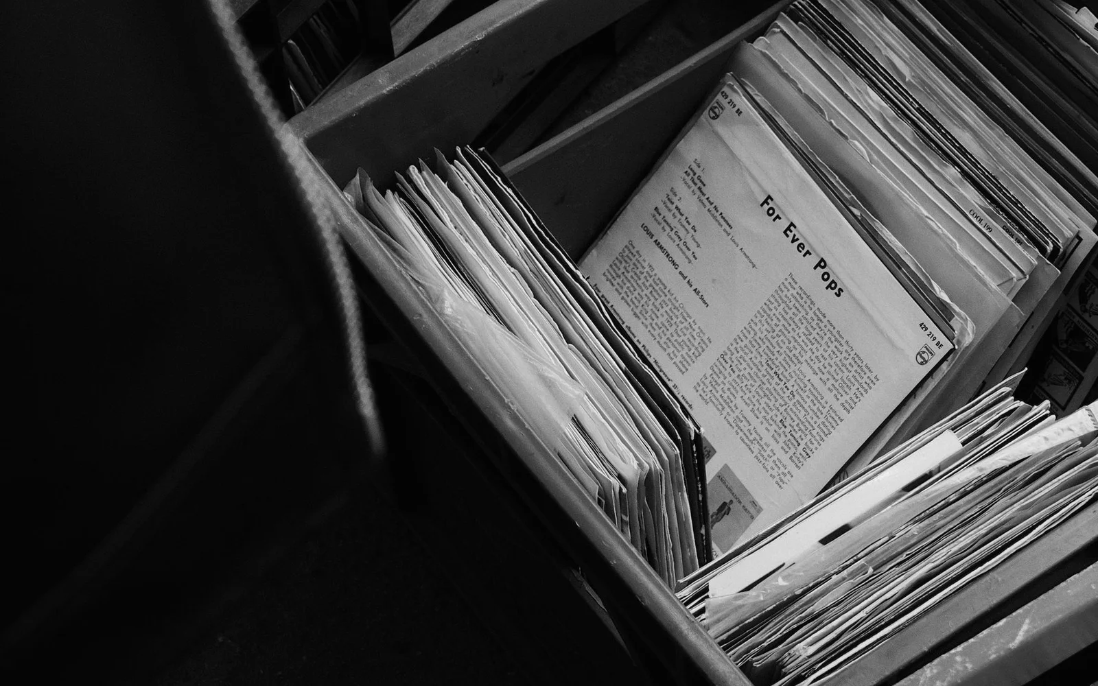 Vinyl records arranged in crates at a record shop
