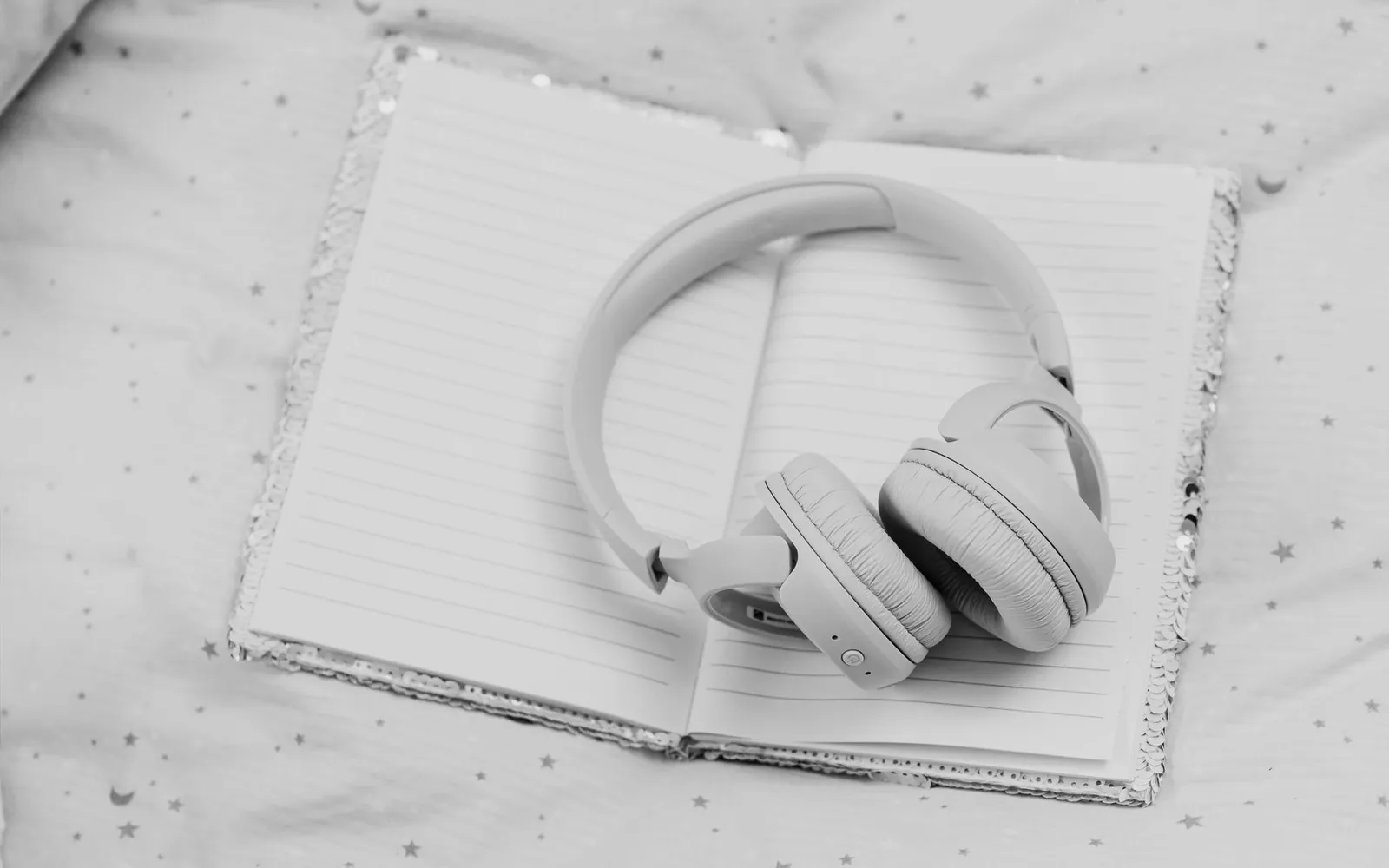 Over-ear headphones resting on a notebook