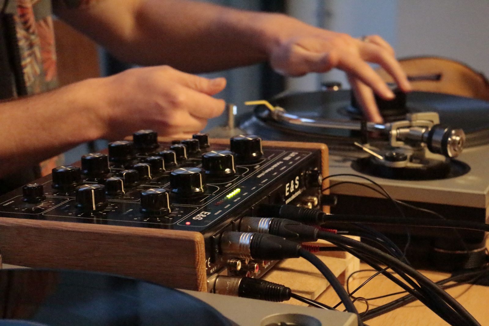 A turntable beside an audio mixer