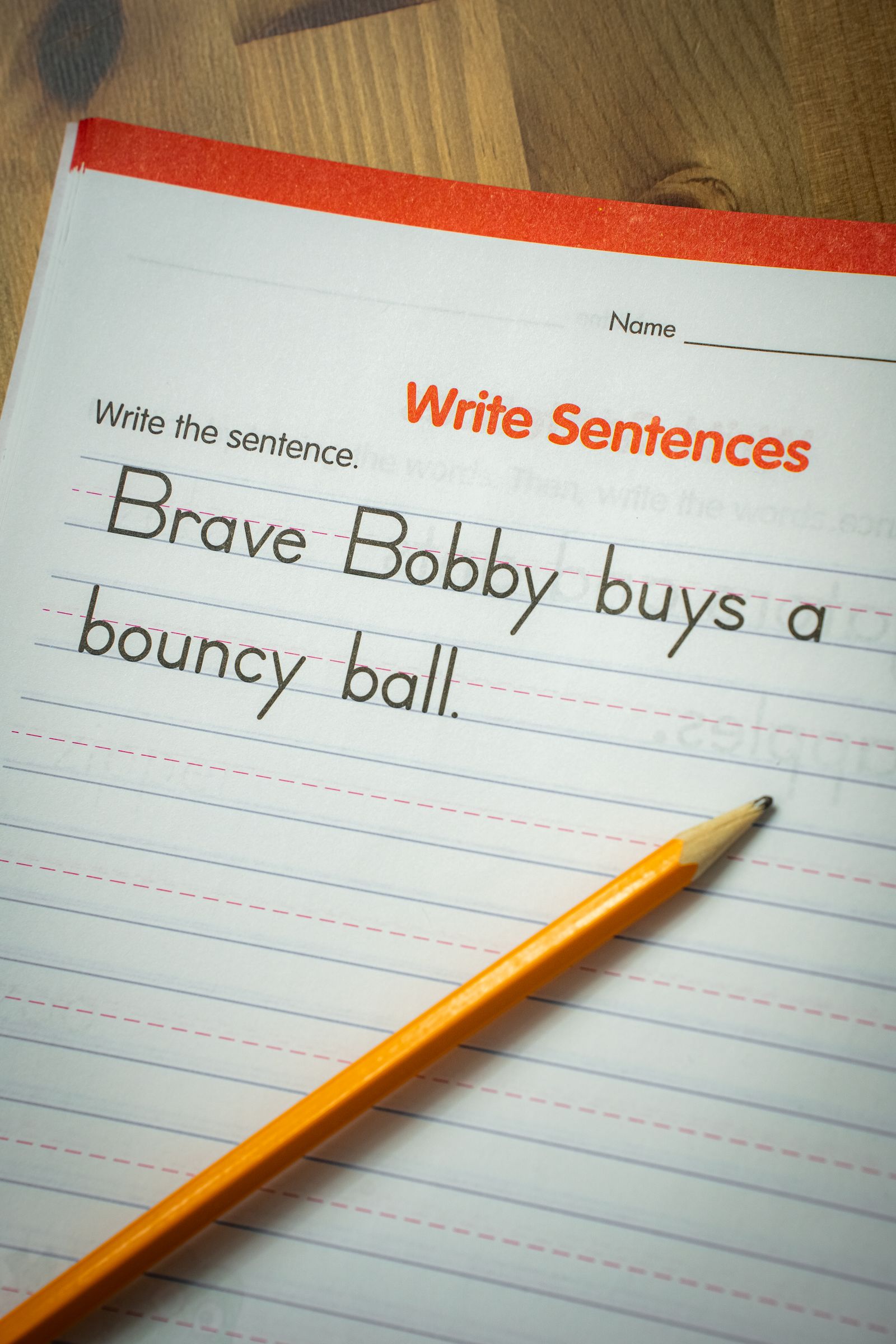 A pencil resting on a handwriting workbook