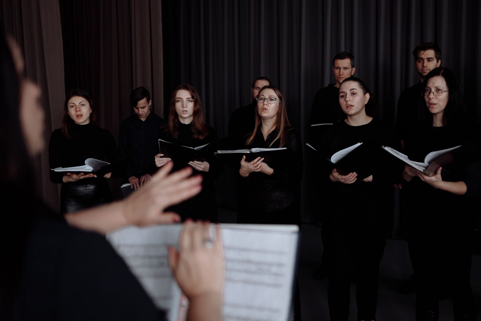 A choir singing from music sheets