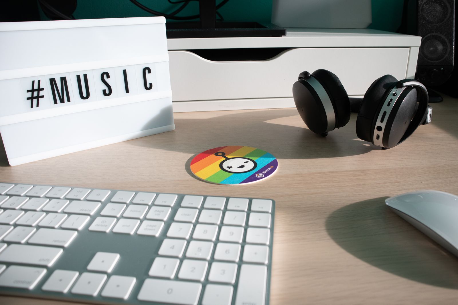 Headphones and a computer keyboard on a desk