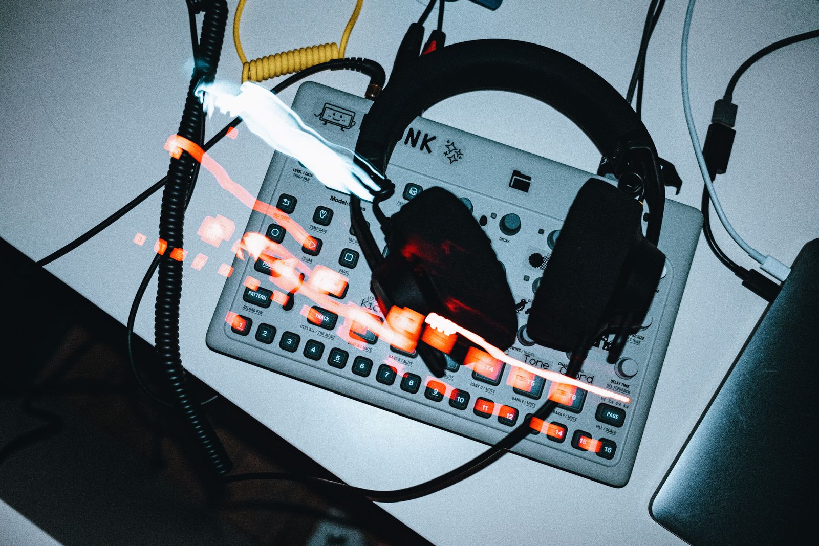 Headphones resting on an electronic drum machine